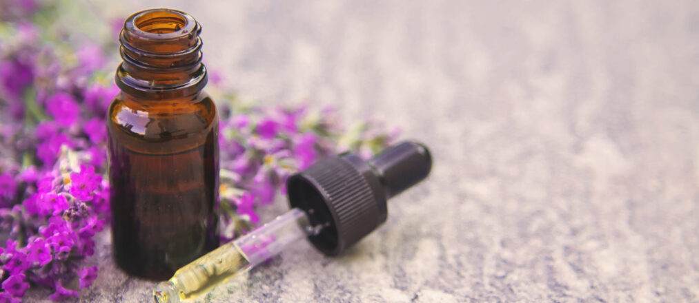 Lavender essential oil in a small bottle. Selective focus.